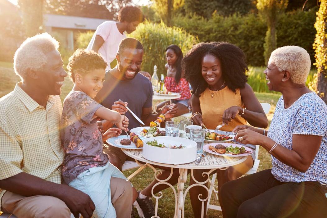 Black Multi Generation Family Eating at a Table in Garden